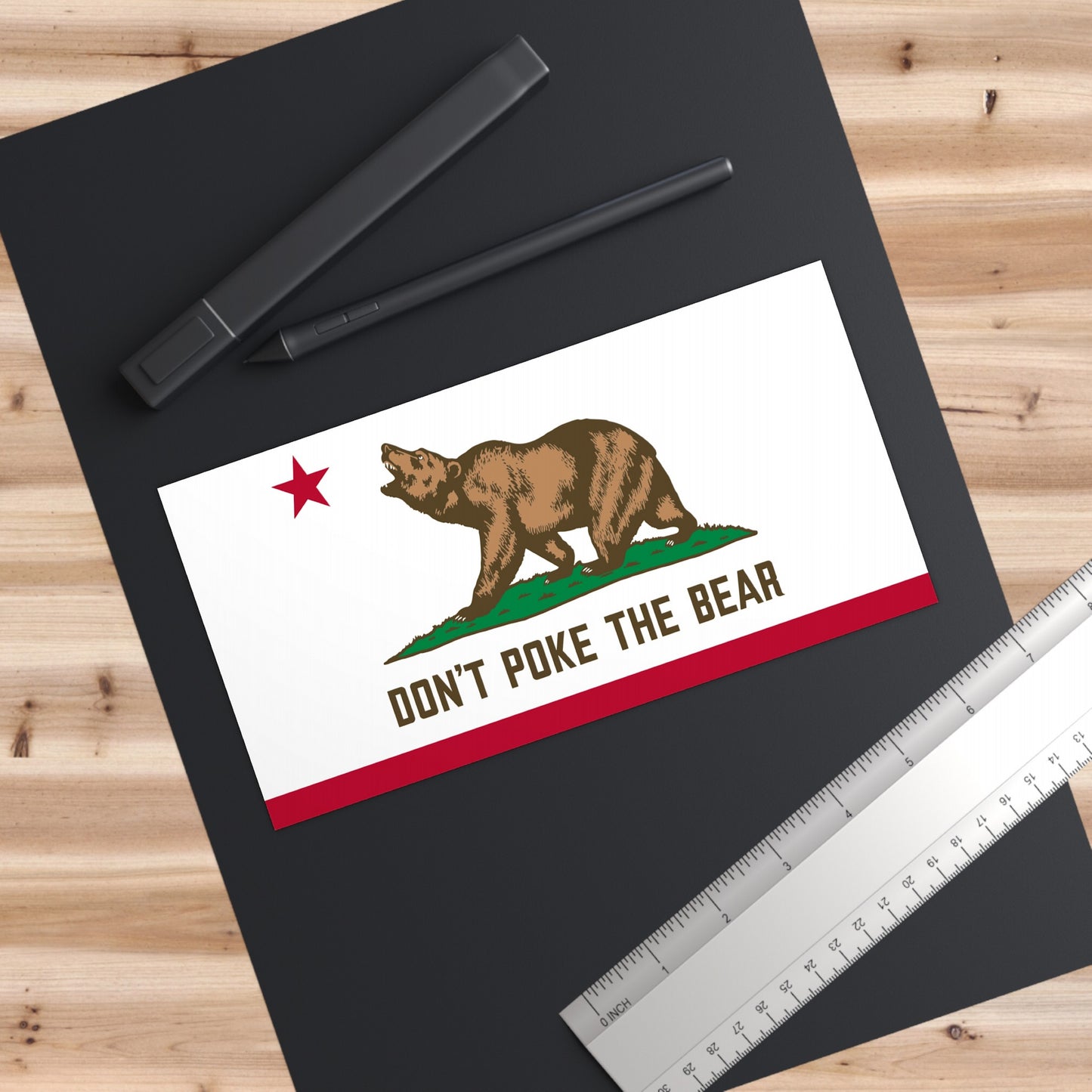 Don’t Poke The Bear sticker placed on a desk surface, California political decor for workspaces or organizing hubs