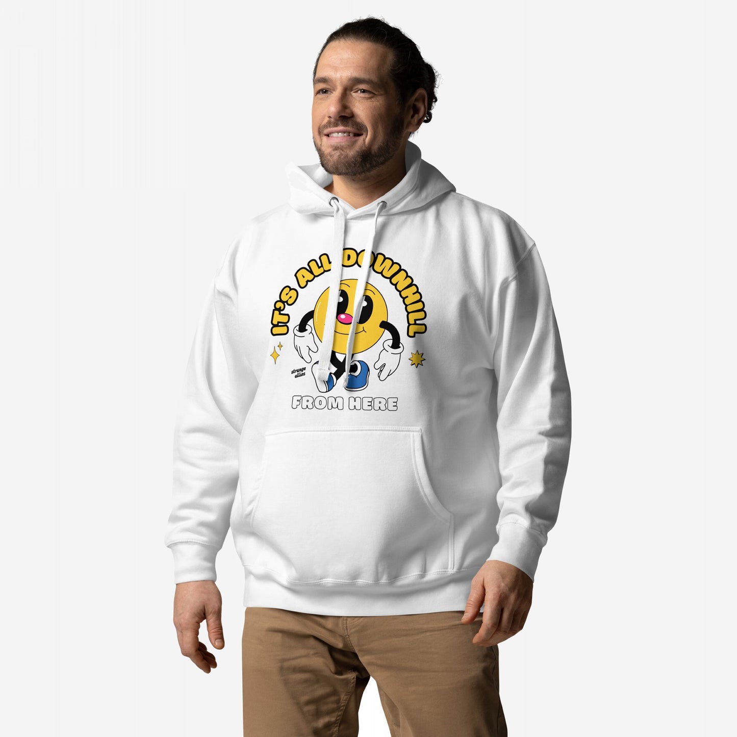 Man wearing Downhill Hoodie & Sweatshirt with a playful yellow cartoon character and It’s All Downhill From Here slogan, embodying a blend of realism and humor against a plain backdrop.