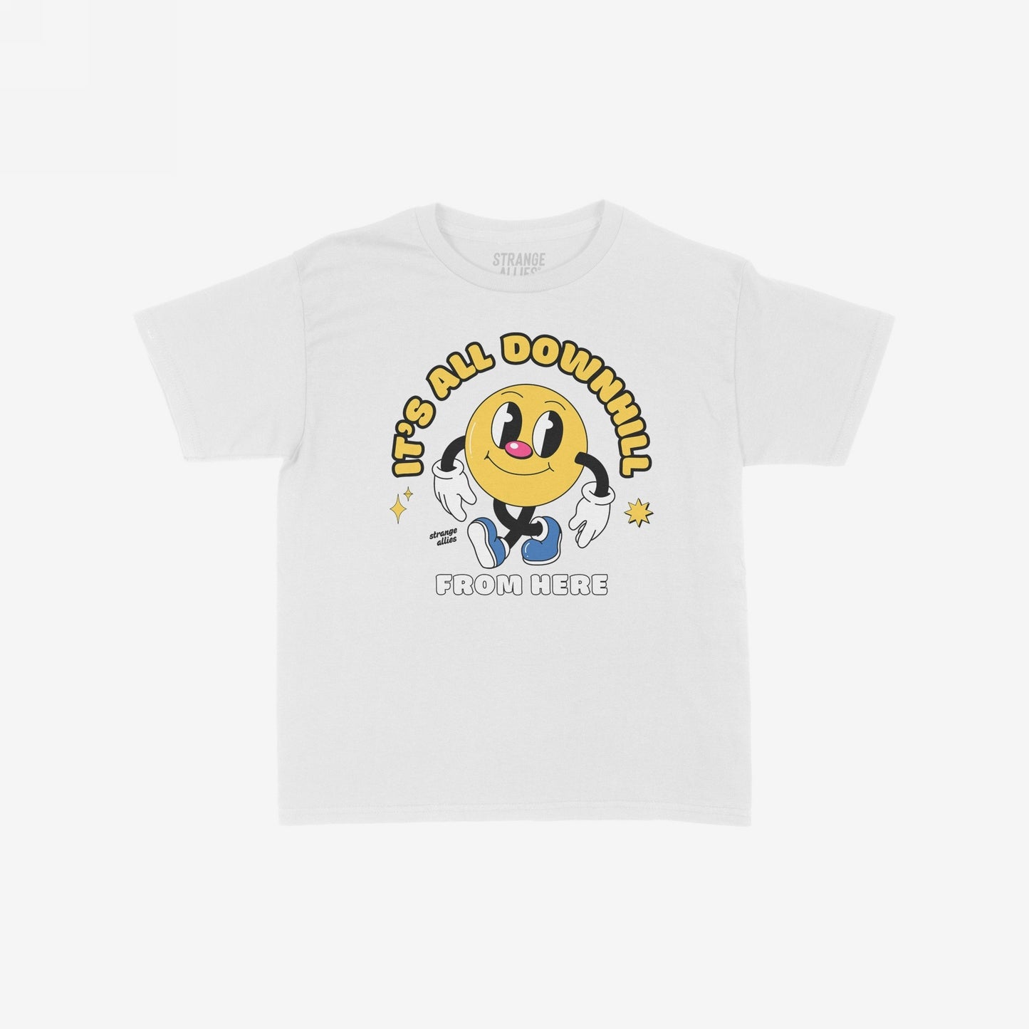Downhill T-shirt featuring a cheerful yellow character with gloves and sneakers, surrounded by sparkles, with the phrases “IT’S ALL DOWNHILL” and “FROM HERE” in playful, vintage-style lettering.