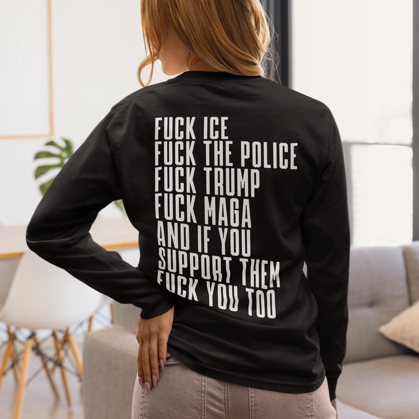 Person wearing the Fuck 'Em All Back Print T-shirt with bold protest text against ICE, police, Trump, and MAGA, reflecting an anti-fascist stance. Ideal for making a statement in public spaces.