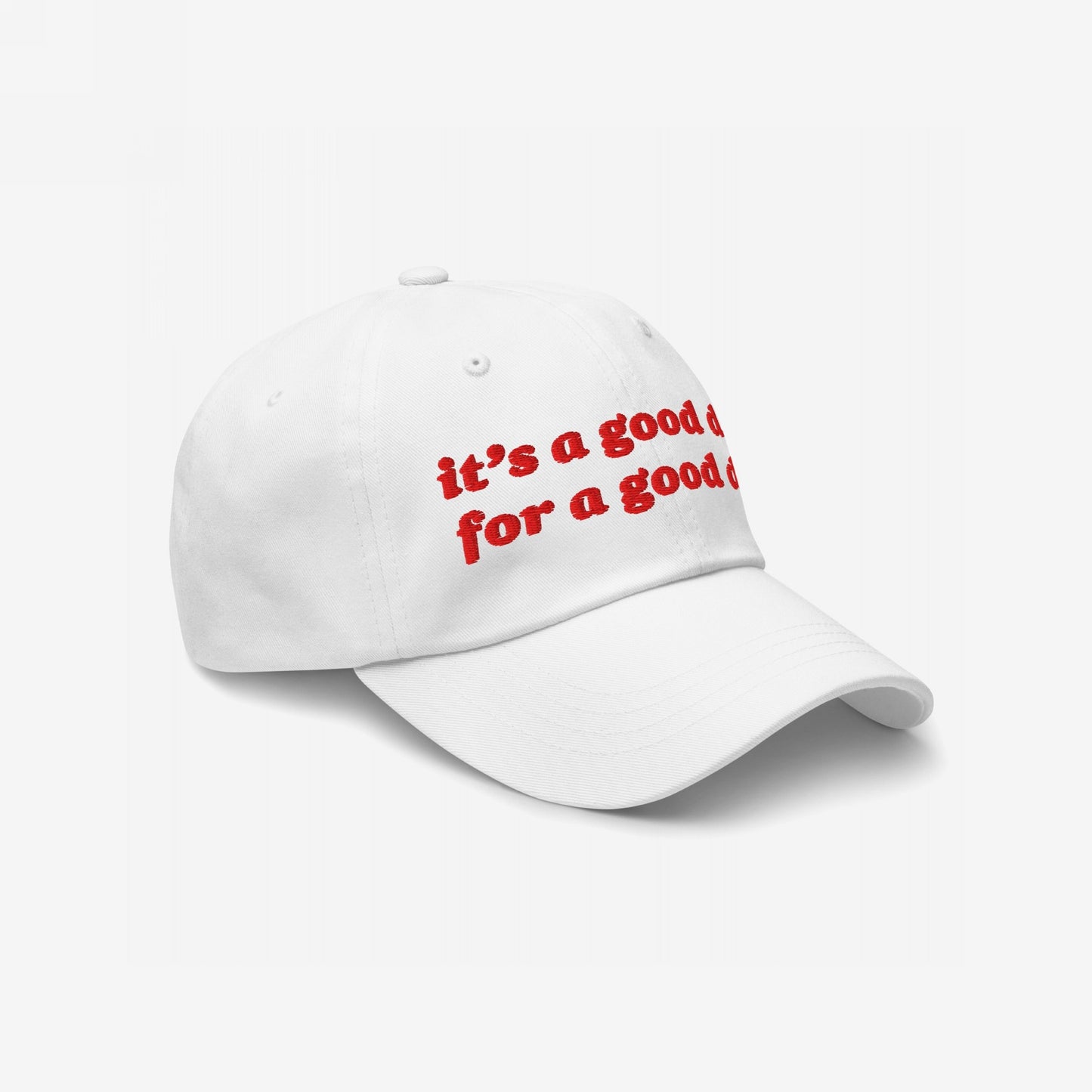 The Good Day Hat features bold red embroidery stating it’s a good day for a good day on a white baseball-style cap, embodying optimism and advocacy for positive mental health.