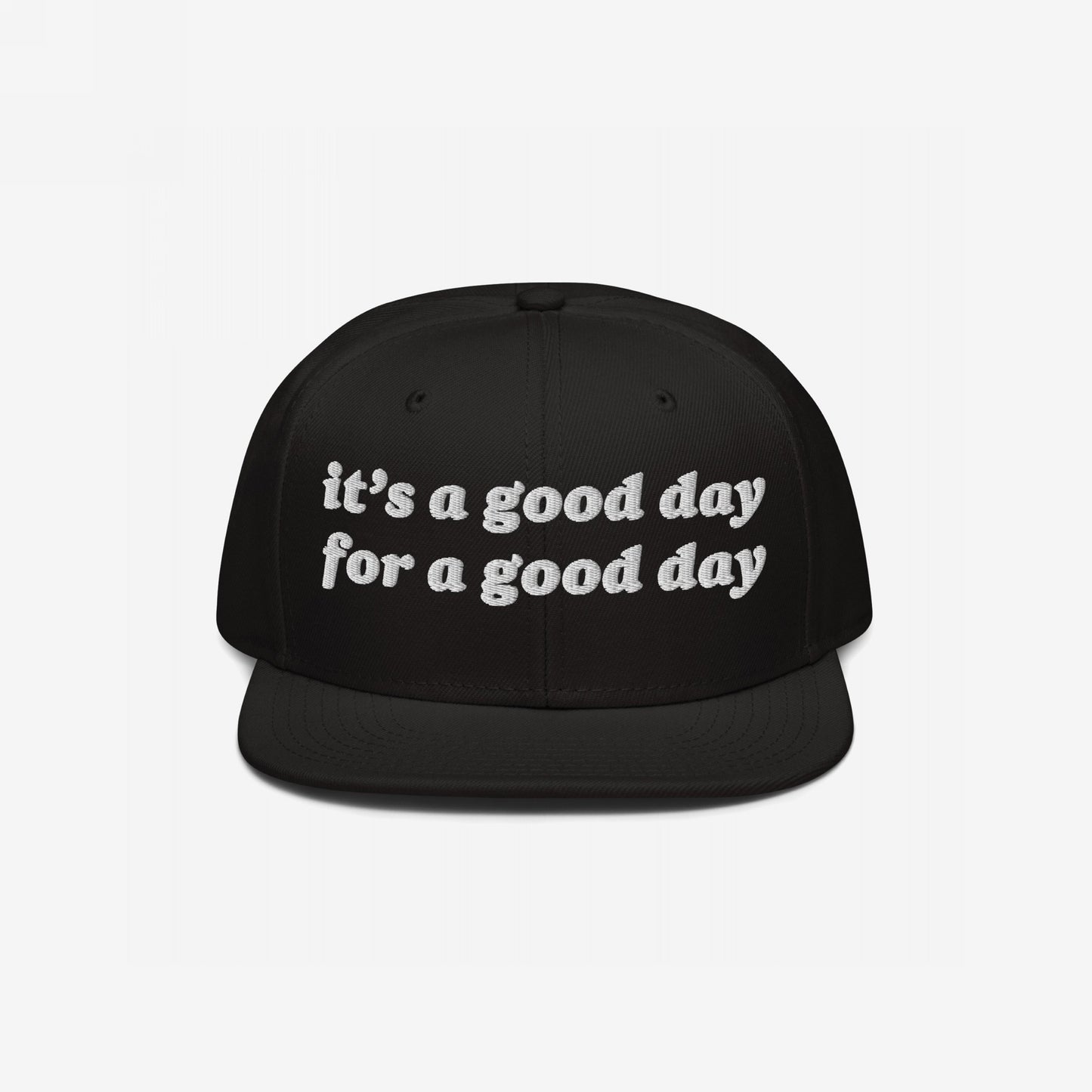 Black flat-brim cap with white embroidered text: “it’s a good day for a good day.” This Good Day Hat combines retro style with positive vibes, perfect for advocating mental health and optimism.