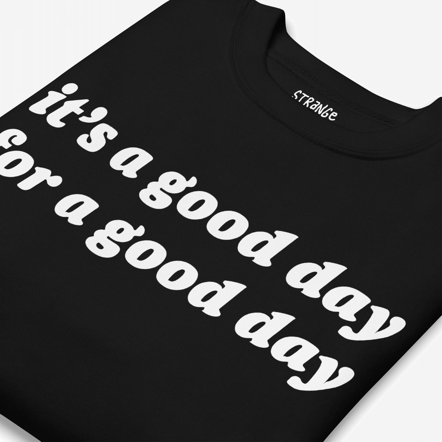 Folded black T-shirt with bold white text on front: “it’s a good day for a good day.” Neck label reads “STRANGE.” Part of the Good Day Hoodie & Sweatshirt collection, promoting optimism and positivity.