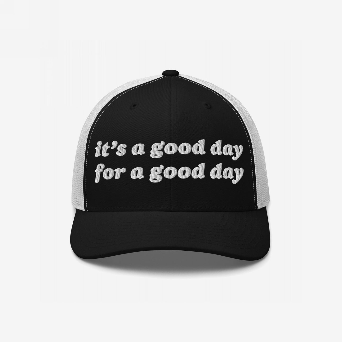 The Good Day Hat features a black front and brim with white mesh panels, showcasing it's a good day for a good day in white embroidery, embodying positive vibes and mental health advocacy.