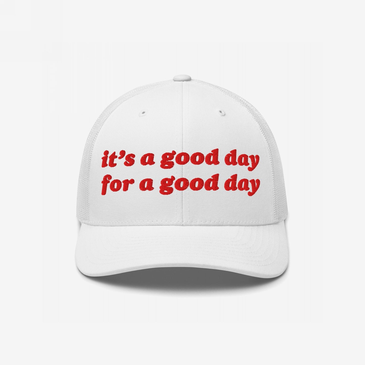 Good Day Hat: white trucker-style cap with red embroidered uplifting text, curved brim, and mesh back. Ideal for promoting positive vibes and supporting mental health advocacy.