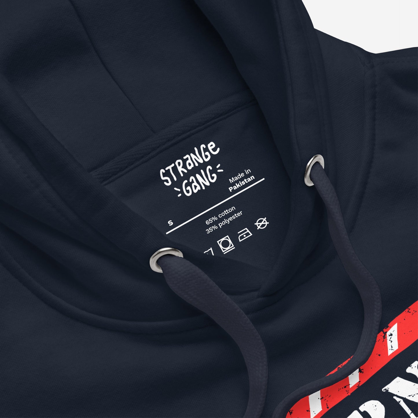 Governed By Criminals Hoodie close-up showing the hood with drawcords, neckline, and inner label. Part of a red-and-white graphic is visible, highlighting its bold, protest-inspired design.
