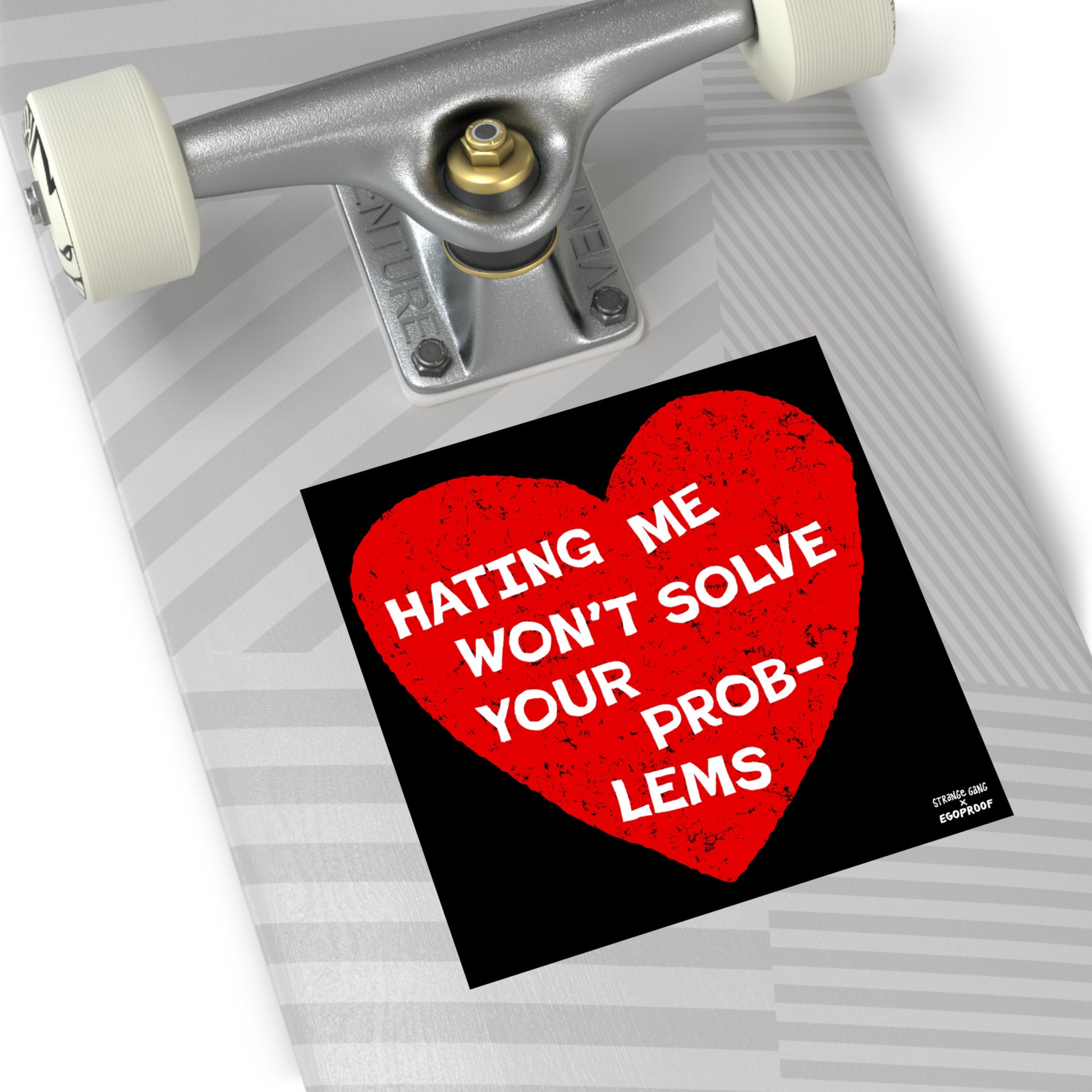 No Hate Sticker & Magnet on skateboard deck shows a distressed red heart with bold text, promoting equality and inclusion, part of a collaboration with EGOPROOF.