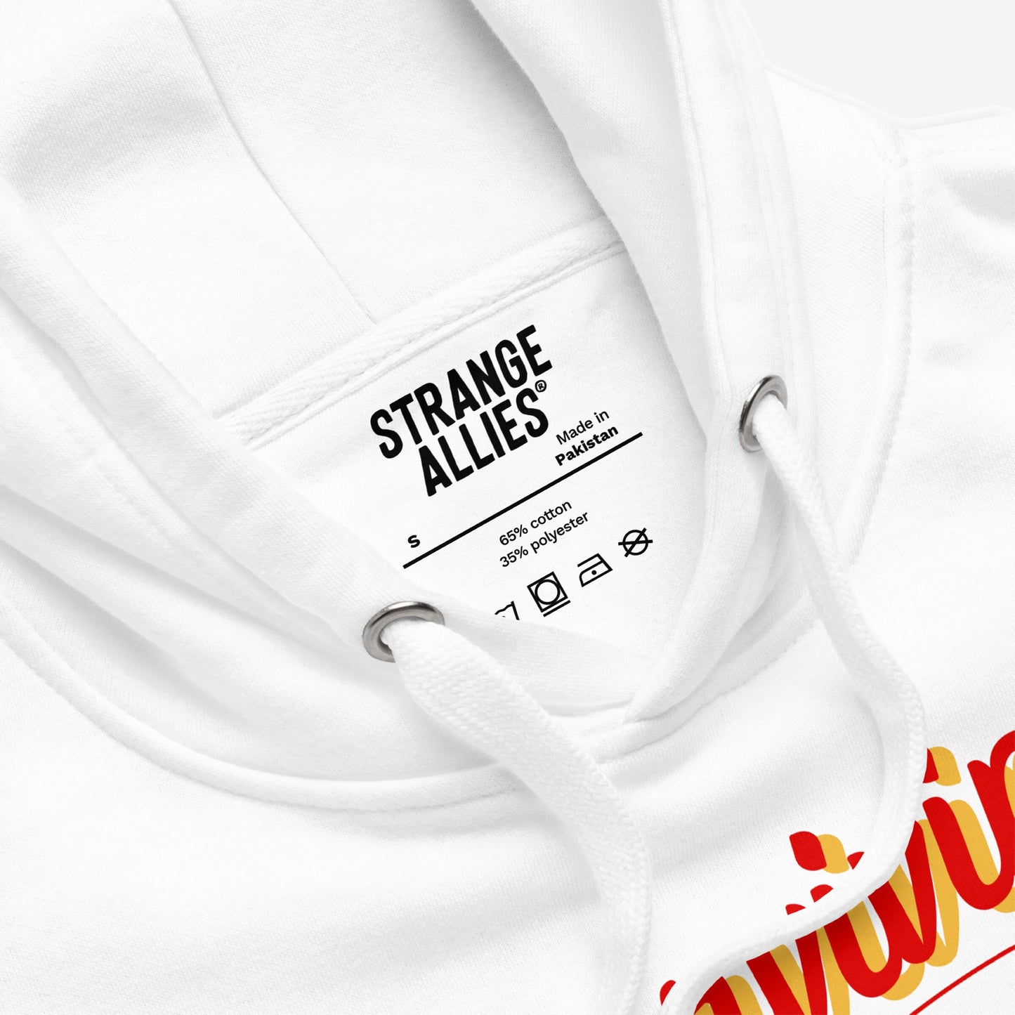Close-up of the Hopium Hoodie & Sweatshirt's inside-neck area, showing a care label and metal eyelets. A hint of a red-and-yellow graphic appears at the bottom edge.