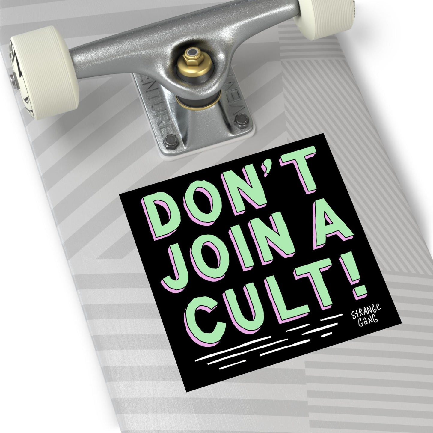 A skateboard deck tail displays the Don't Join A Cult sticker, promoting critical thinking and challenging authoritarianism. The sticker, signed by Strange Gang, advocates equality and resistance to blind allegiance.