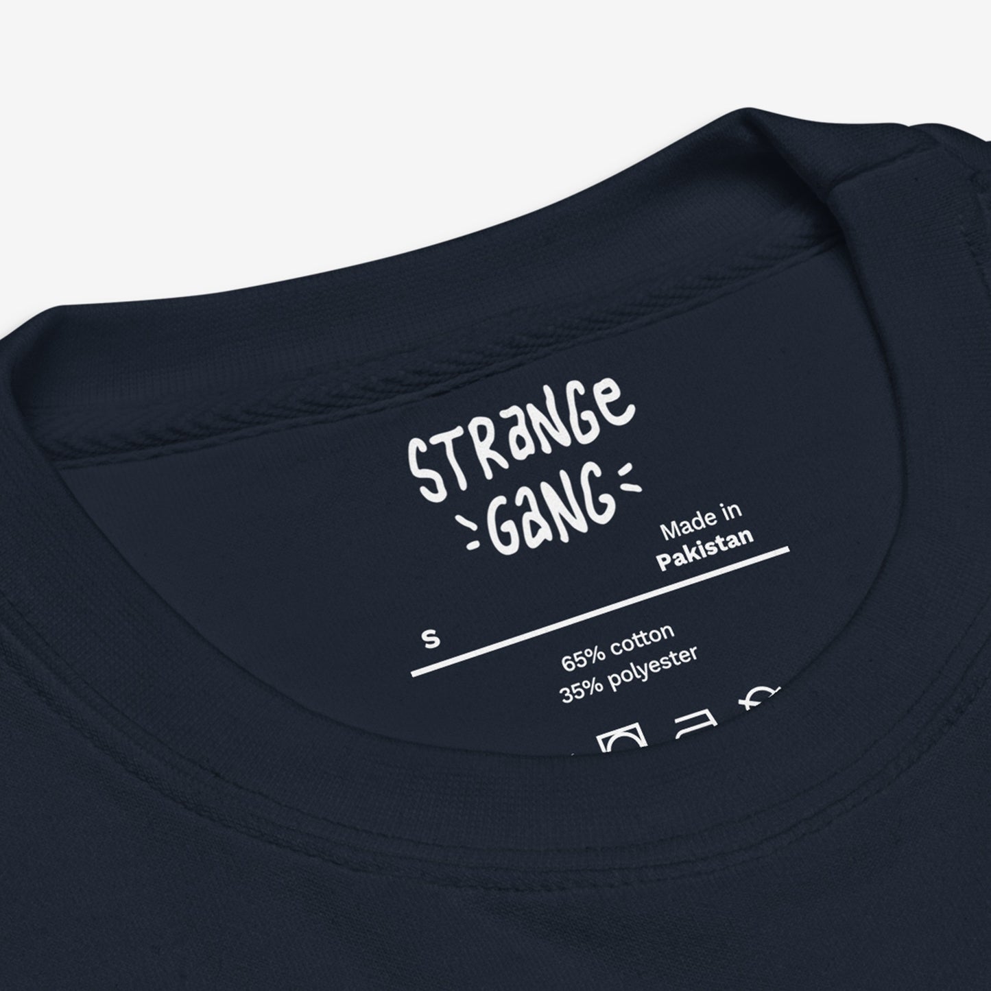 Inside back neckline of a navy T-shirt showing brand details, size S, and care instructions. The Chicago Gadsden Flag Hoodie & Sweatshirt features protest-inspired urban pride, emphasizing Chicago's resistance spirit.