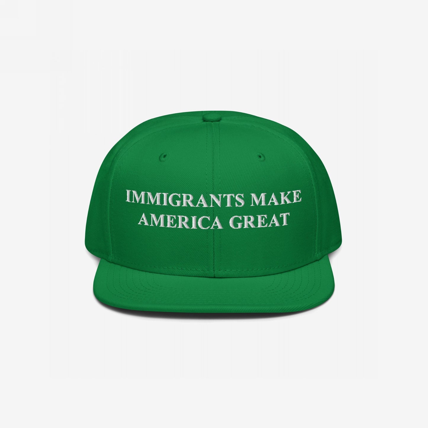 Bright green flat-bill baseball cap with bold white embroidery, reading IMMIGRANTS MAKE AMERICA GREAT, symbolizes resilience and advocacy for immigrant rights.