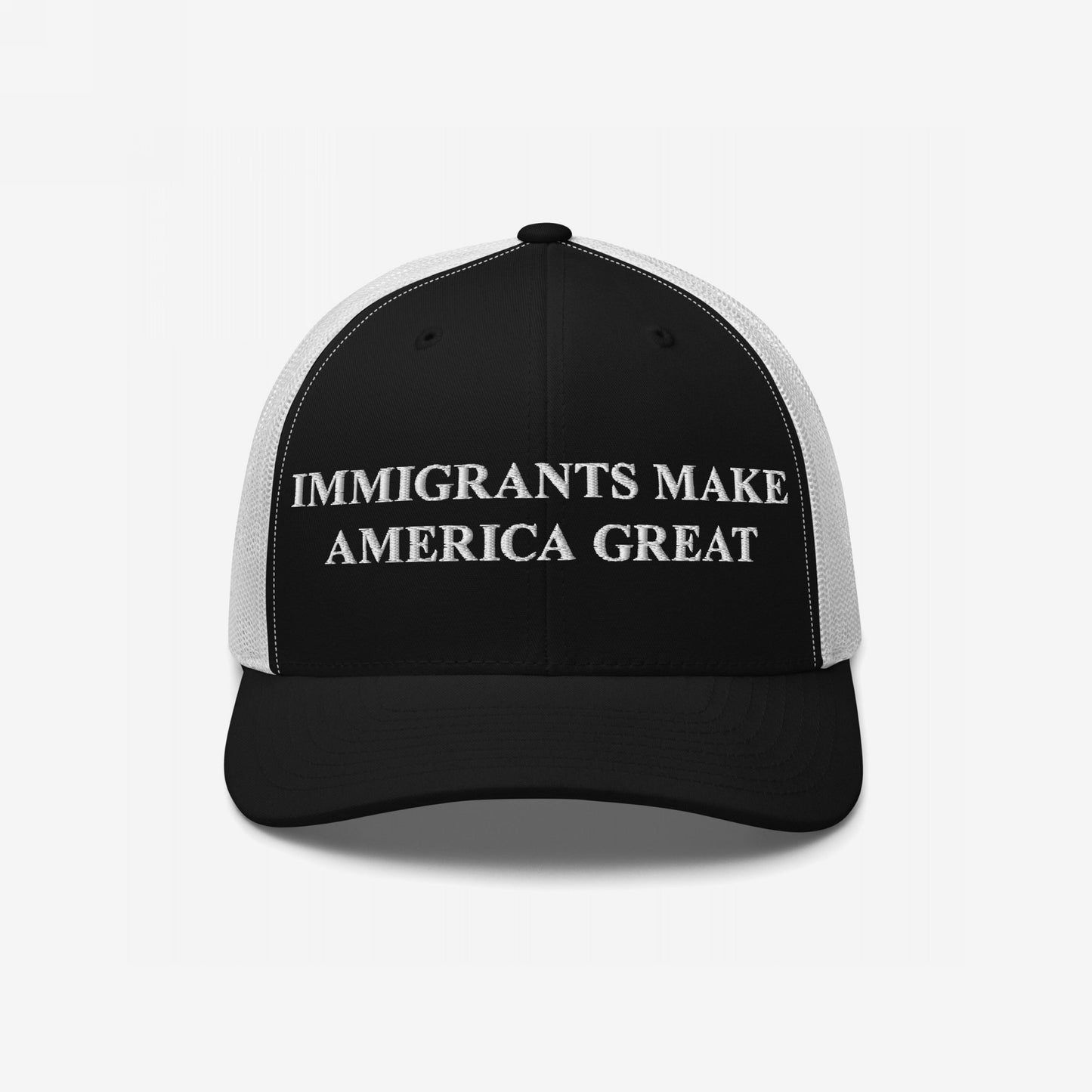 Black-and-white mesh-back trucker cap featuring bold Immigrants Make America Great text on the front, symbolizing support for immigrant rights and equality. Ideal for rallies or everyday wear.