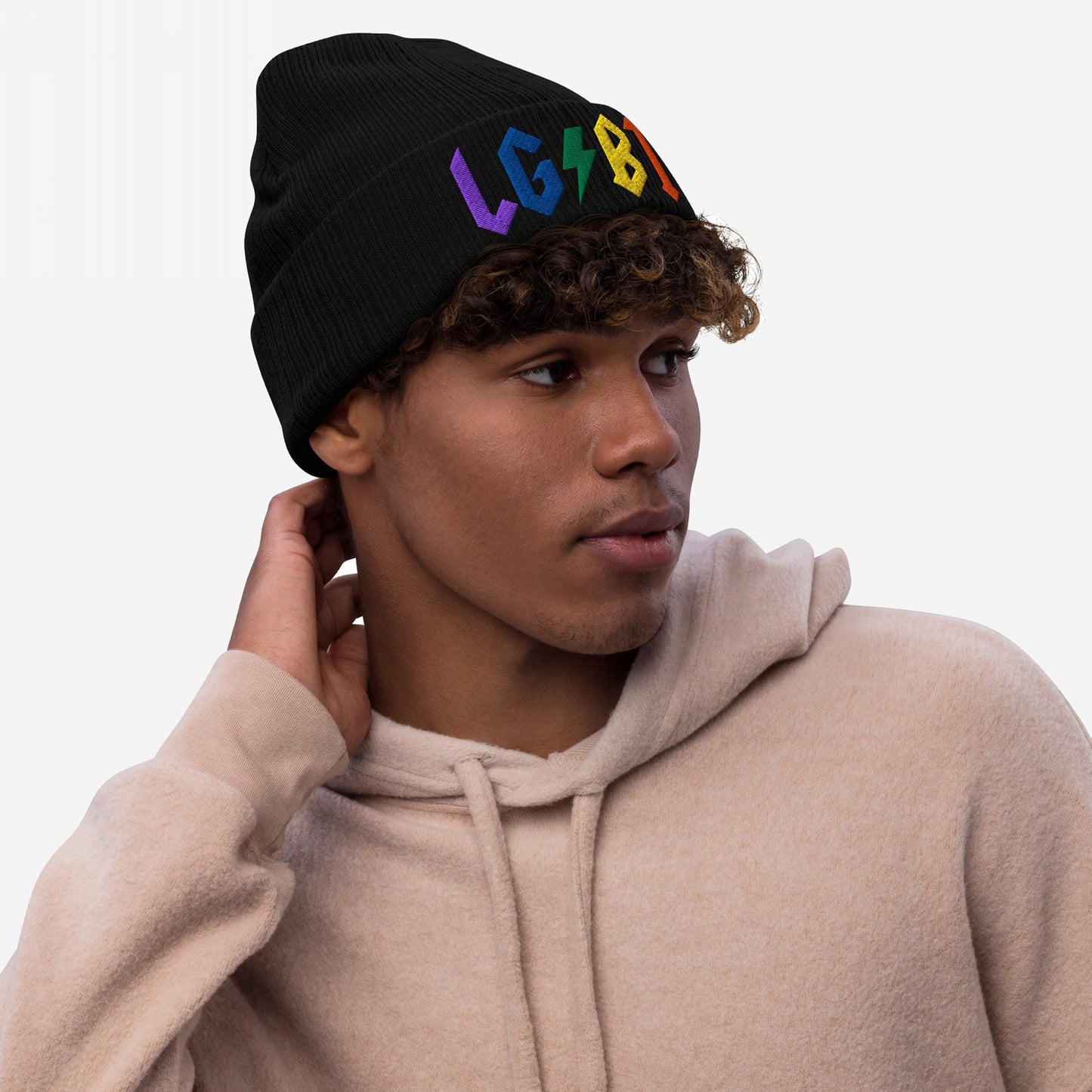 Young person wearing a black beanie with colorful LGBTQ Rocks Hat embroidery, showing pride and rock and roll attitude.