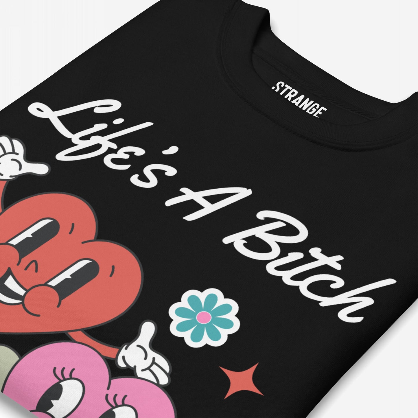 Life's A Bitch Hoodie & Sweatshirt features “Life’s A Bitch” script with cartoon hearts, a blue flower, and a red starburst, capturing a bold, honest statement.