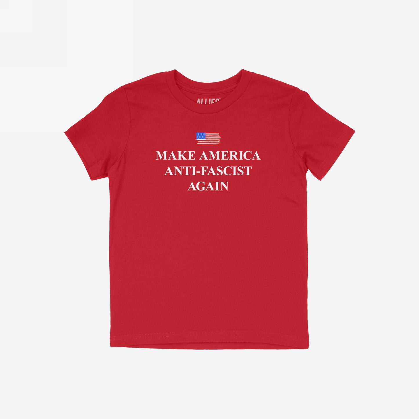 Plain red T-shirt titled Make America Anti-Fascist Again features a hand-sketched American flag graphic at chest level and bold serif slogan, conveying a strong anti-fascist message.