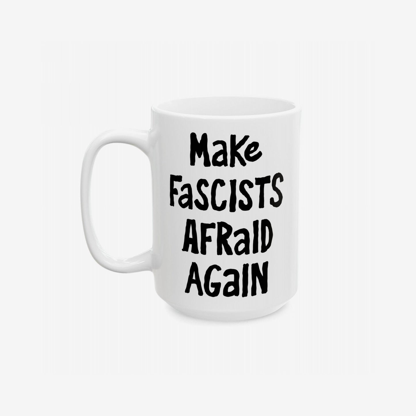 White ceramic Make Fascists Afraid Again mug, featuring bold black lettering. Designed for defiance, it's dishwasher safe with a standard C-handle, embodying protest energy. Ships from the E.U., supports Amnesty International.