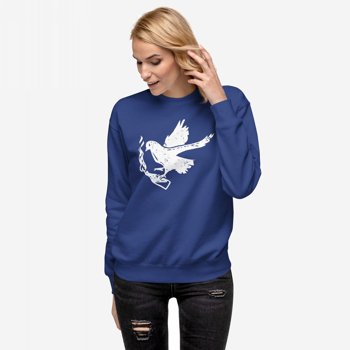 A woman models the Molotov Messenger Hoodie & Sweatshirt featuring a distressed dove with a flaming Molotov, symbolizing peace and power, paired with black ripped skinny jeans against a neutral background.