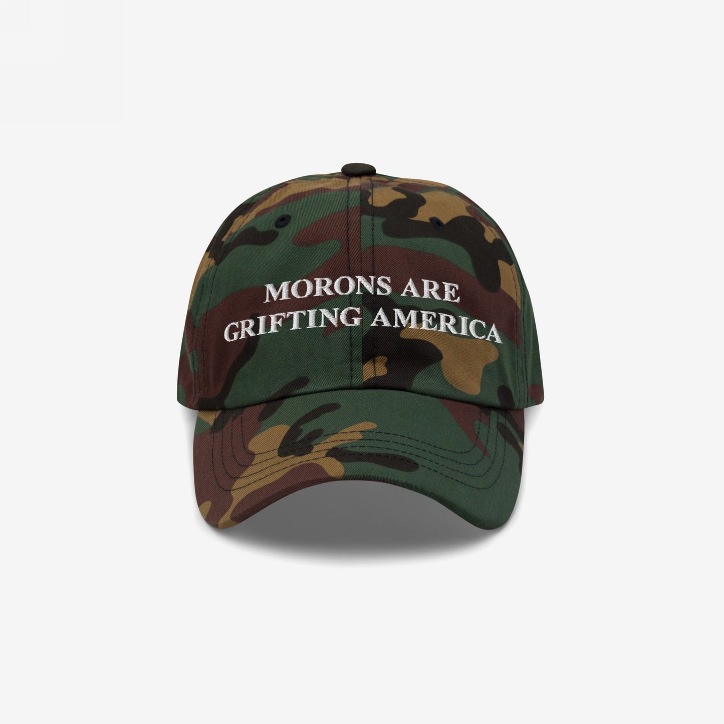 Camouflage-print baseball cap with a curved brim, featuring the embroidered message Morons Are Grifting America in white. Ideal for political realists seeking direct, honest expression. Ships from the E.U.