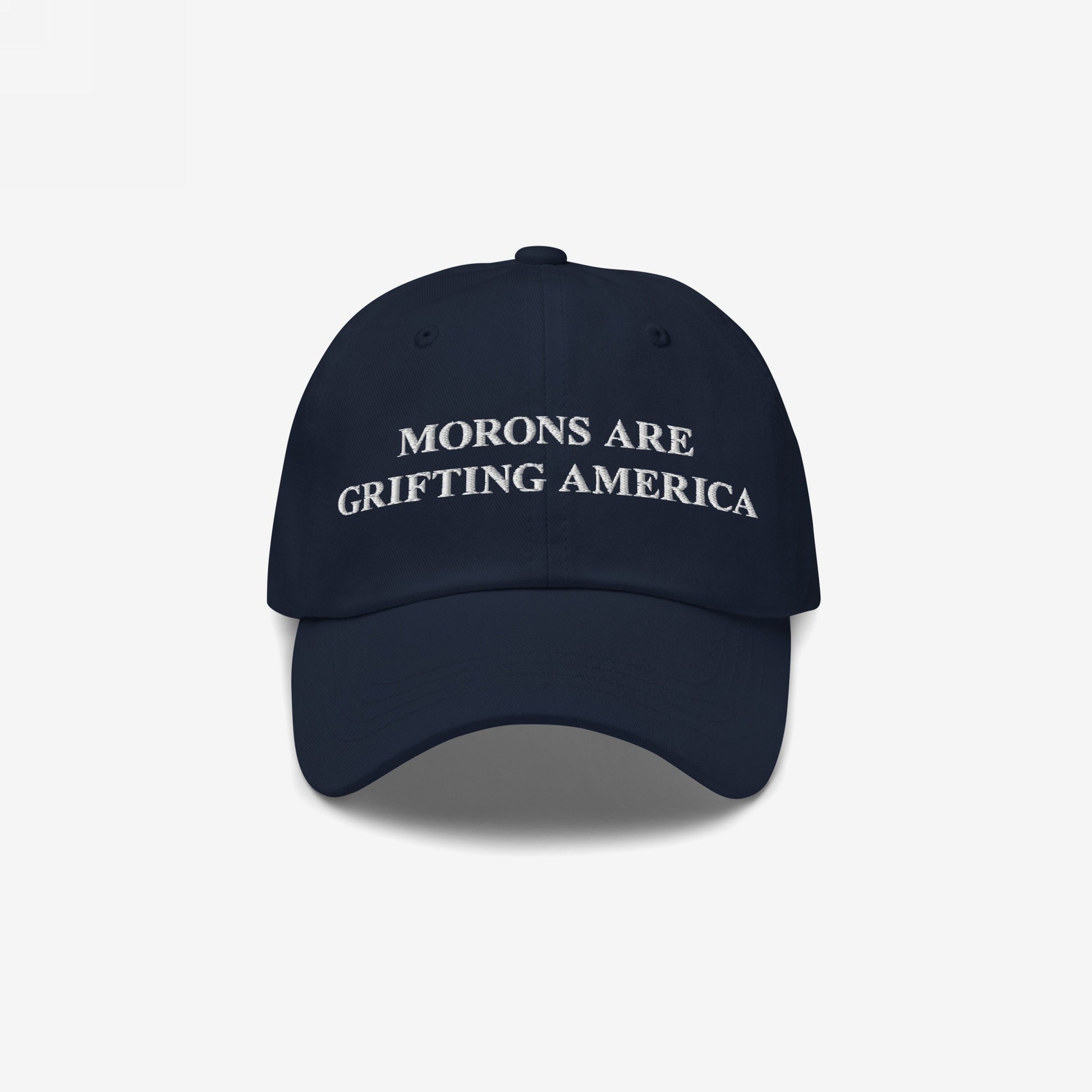 Navy blue dad hat with striking white embroidery of "Morons Are Grifting America" across the front — a sleek, understated take on the anti-MAGA callout.