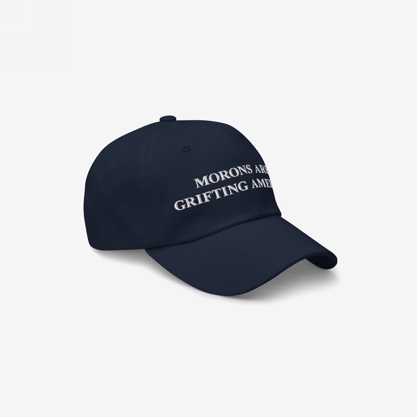 Morons Are Grifting America Hat: A dark-navy, unstructured baseball cap with bold white embroidery, expressing political realism and honesty, captured against a neutral backdrop to highlight its impactful message.