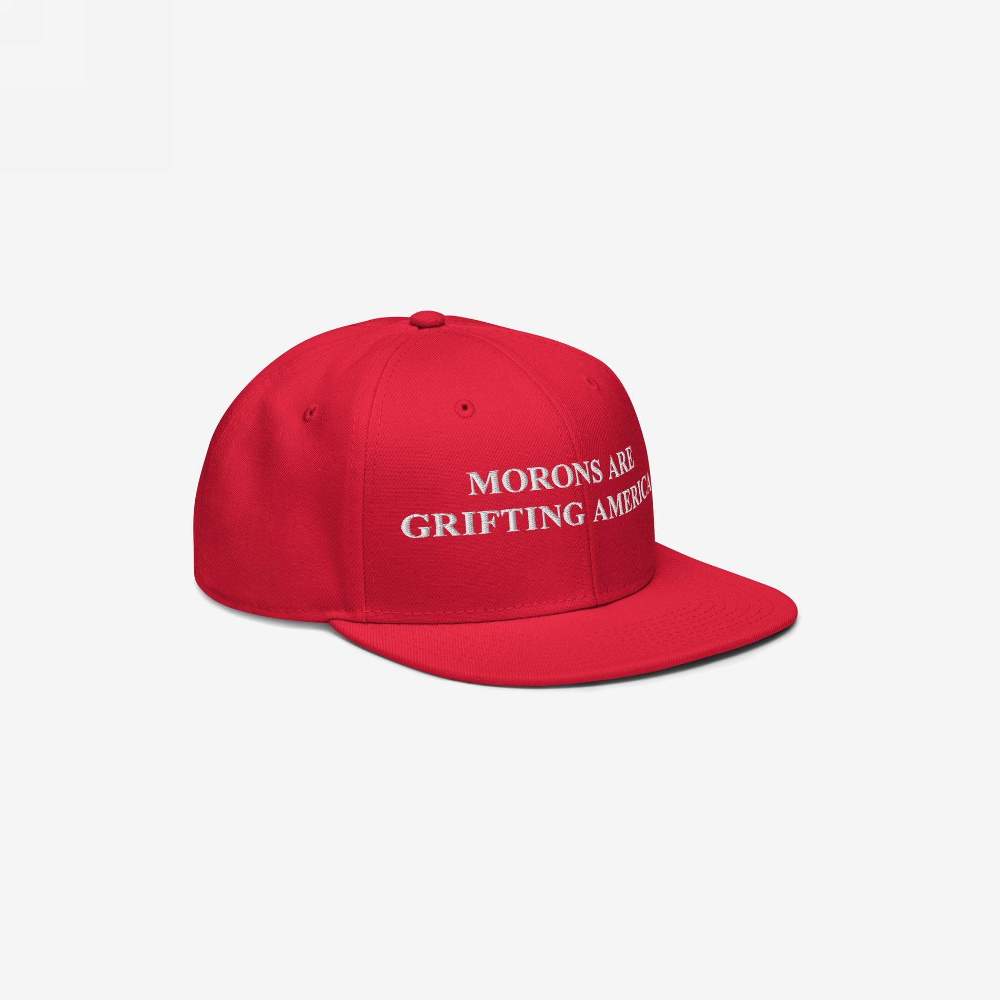 Angled view of red snapback hat with visible white embroidery of "Morons Are Grifting America," styled for strong anti-MAGA visual impact.