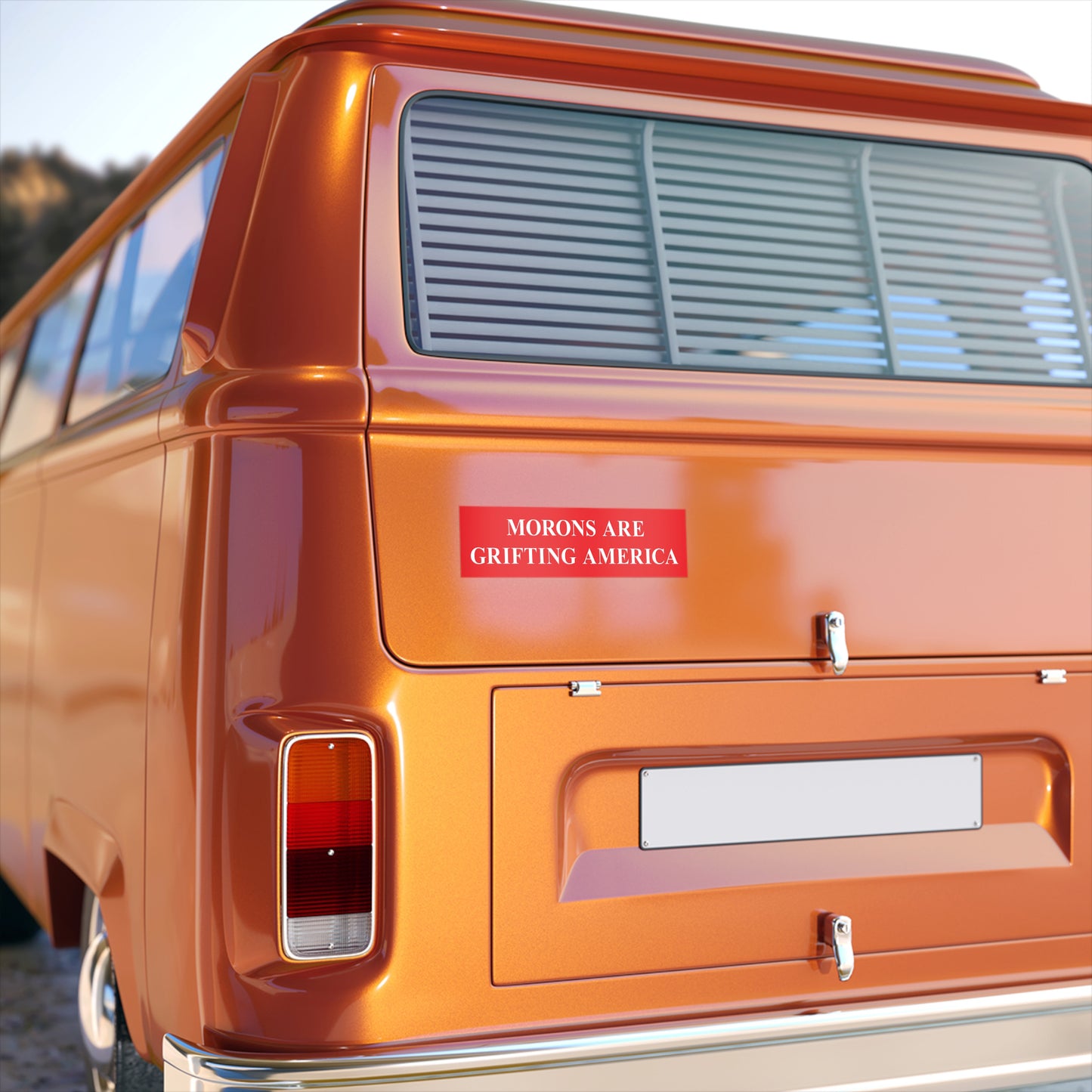 Morons Are Grifting America bumper sticker on an orange van