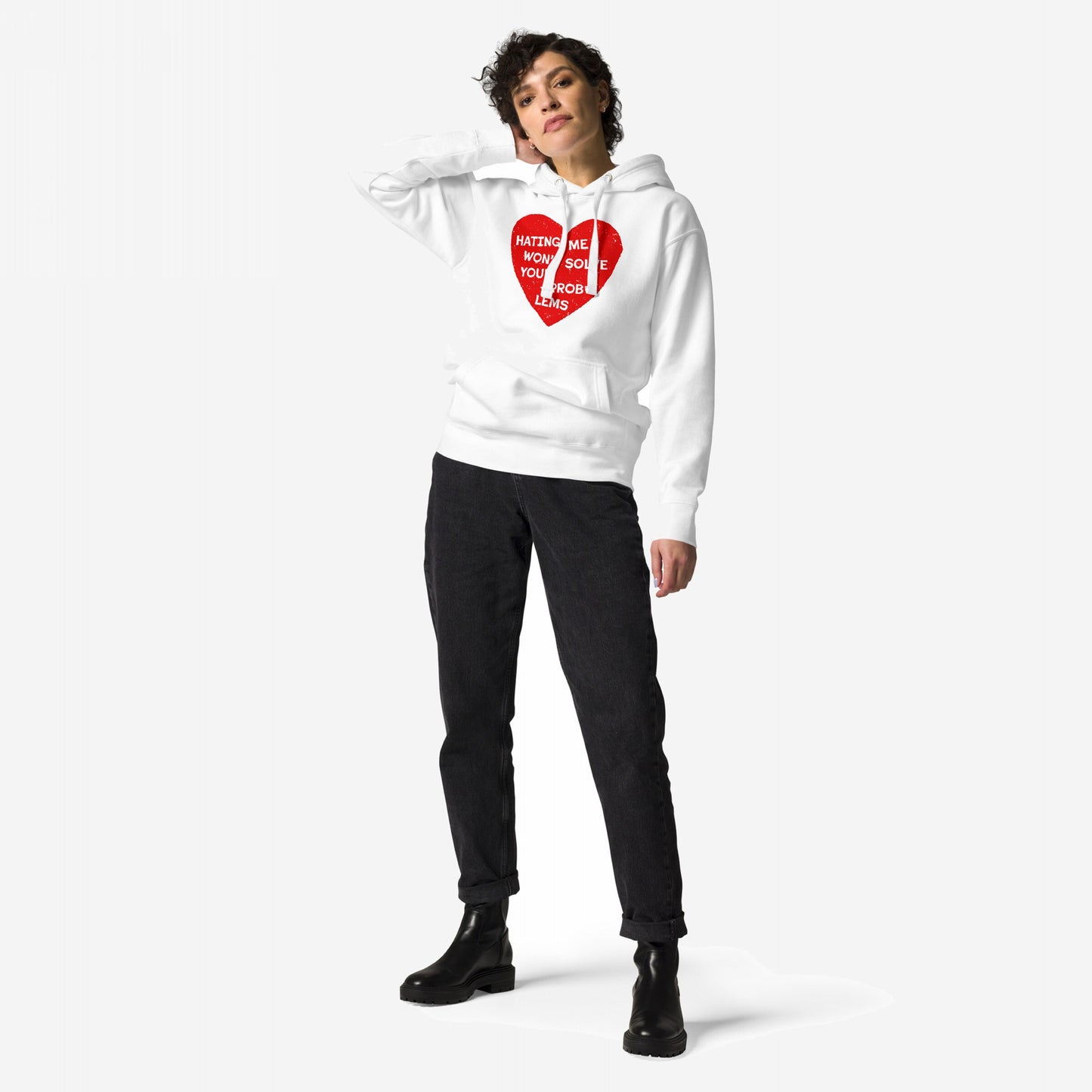 Model wearing the No Hate Hoodie & Sweatshirt featuring a distressed red heart with HATING ME WON’T SOLVE YOUR PROBLEMS, paired with slim-fit black jeans and black lug-sole ankle boots.