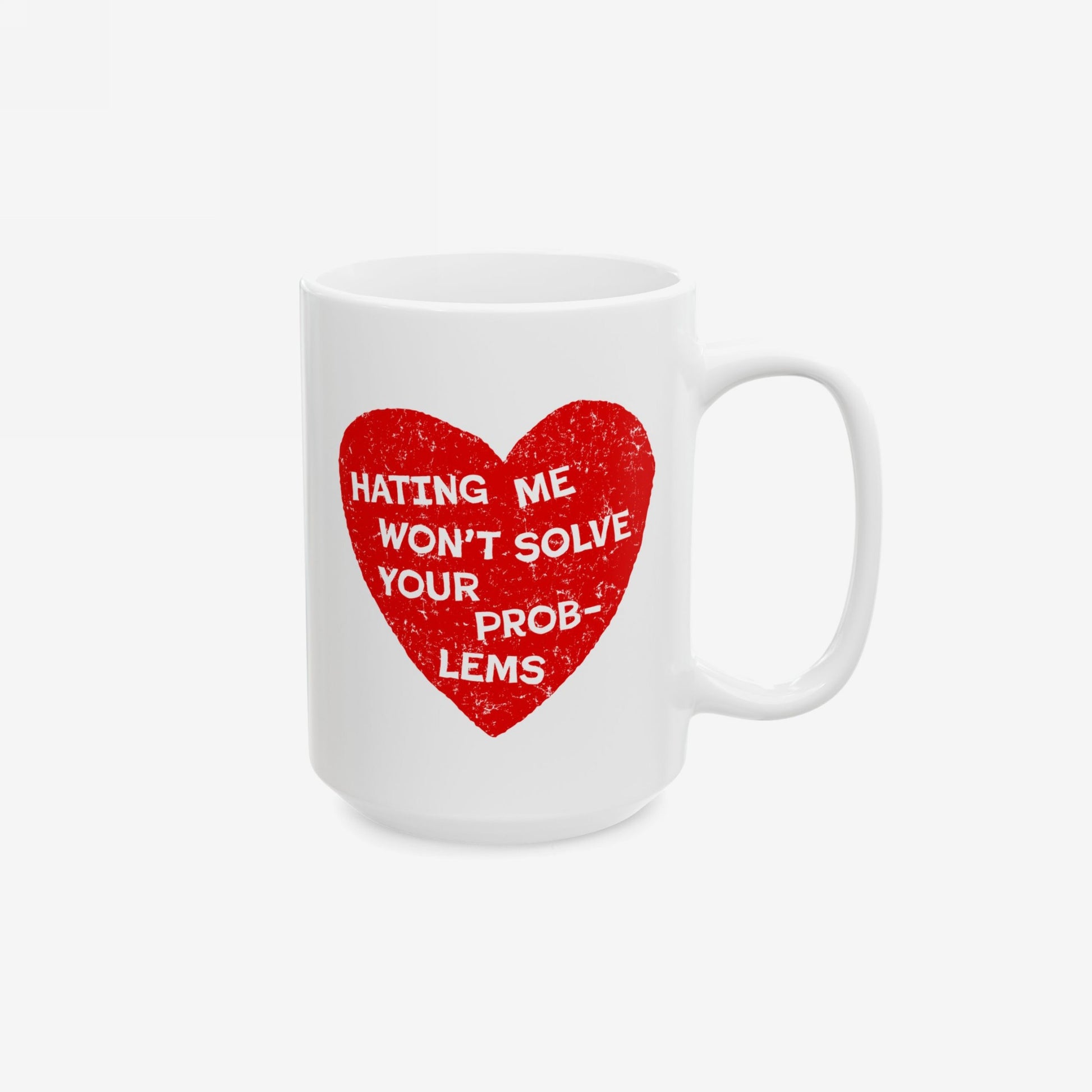 No Hate Mug featuring a distressed red heart with the text, HATING ME WON’T SOLVE YOUR PROB-LEMS, on a white ceramic surface. Ideal for activism and support, promoting empowerment and inclusivity.