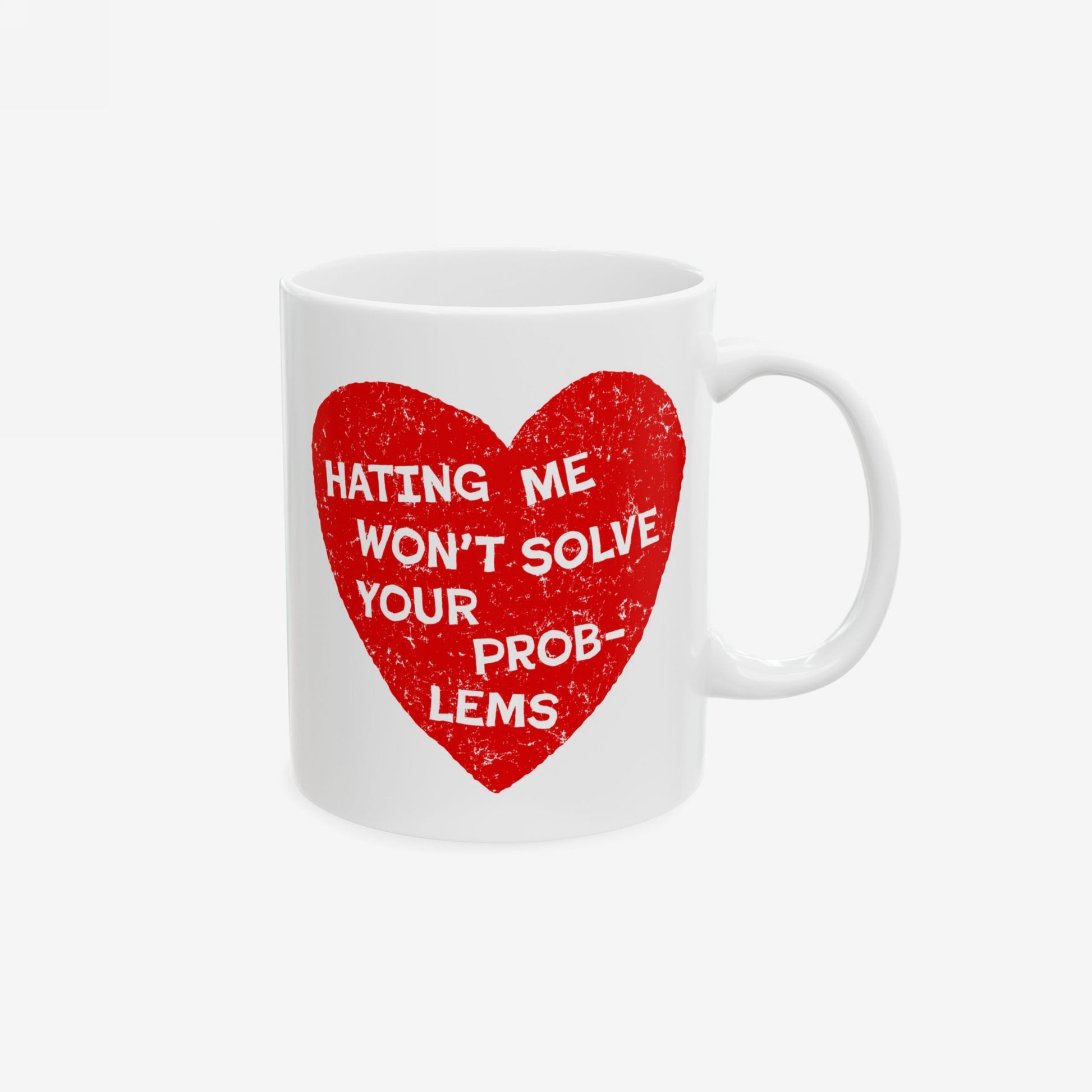 White ceramic No Hate Mug with a distressed red heart displaying HATING ME WON’T SOLVE YOUR PROBLEMS. Perfect for daily motivation, it embodies empowerment and is ideal for equality and mental health advocates.