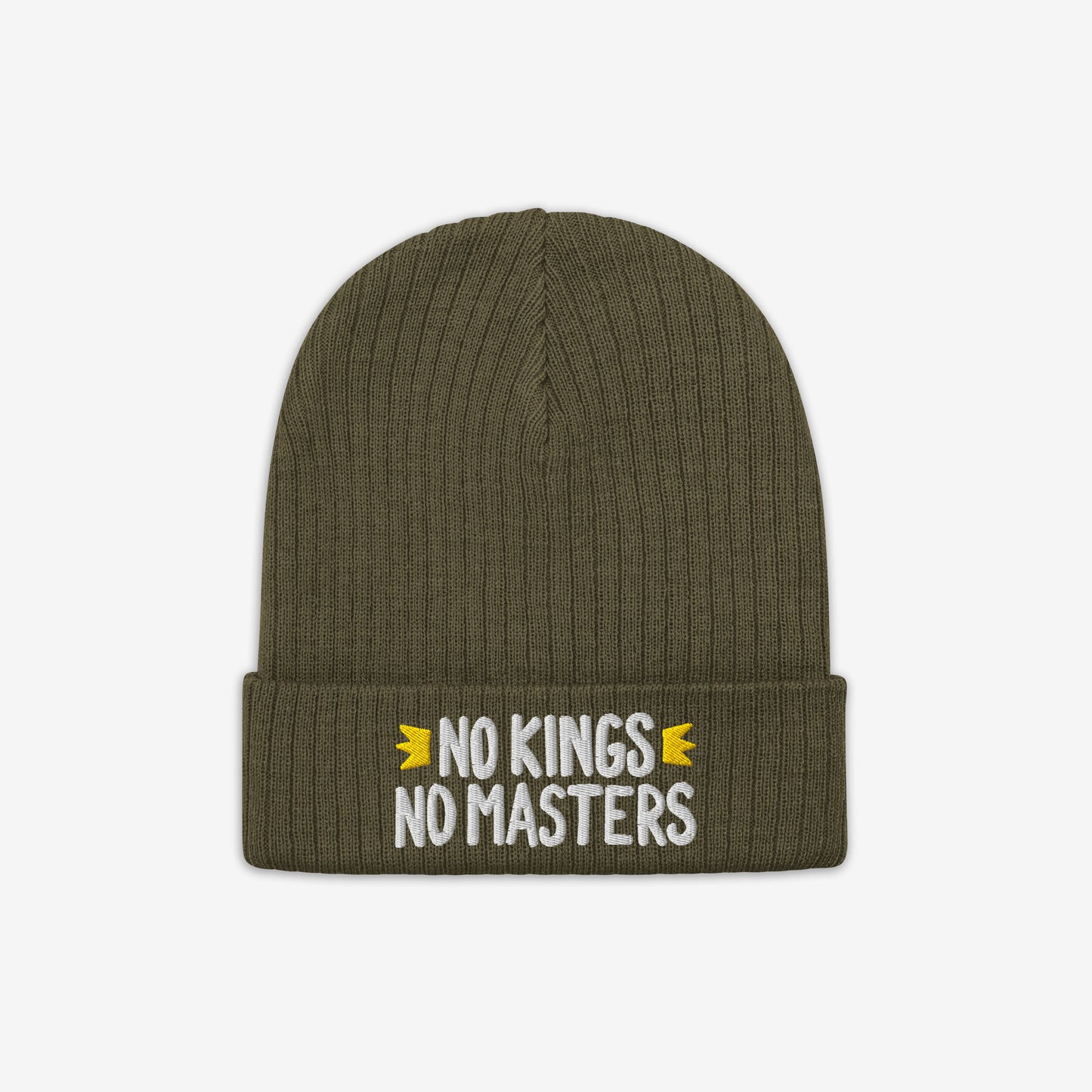 The No Kings No Masters Hat is an olive-green, ribbed knit beanie with a folded cuff, featuring white embroidered text flanked by yellow accents, embodying an anti-authoritarian message.