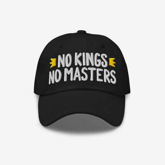 No Kings No Masters Hat featuring a bold embroidered slogan in white, flanked by yellow banners, against a white background. This cap embodies rebellious spirit and stands against authoritarianism.