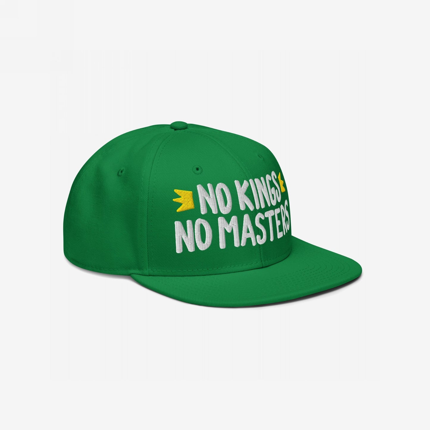Green flat-bill snapback hat with NO KINGS NO MASTERS in white embroidery, accented by small yellow crowns, radiating rebellious spirit and support for equality and freedom.