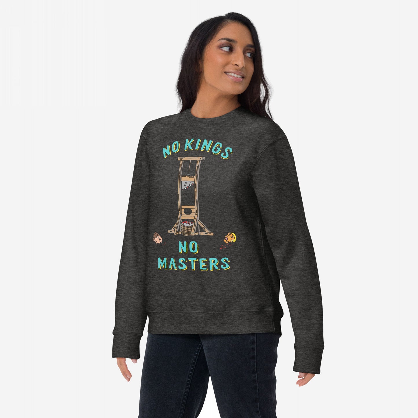 Model wearing 'No Kings No Masters' crewneck sweatshirt, featuring a stylized guillotine graphic with NO KINGS and NO MASTERS text, cartoon heads, and red splatter, symbolizing anti-authoritarian sentiment.
