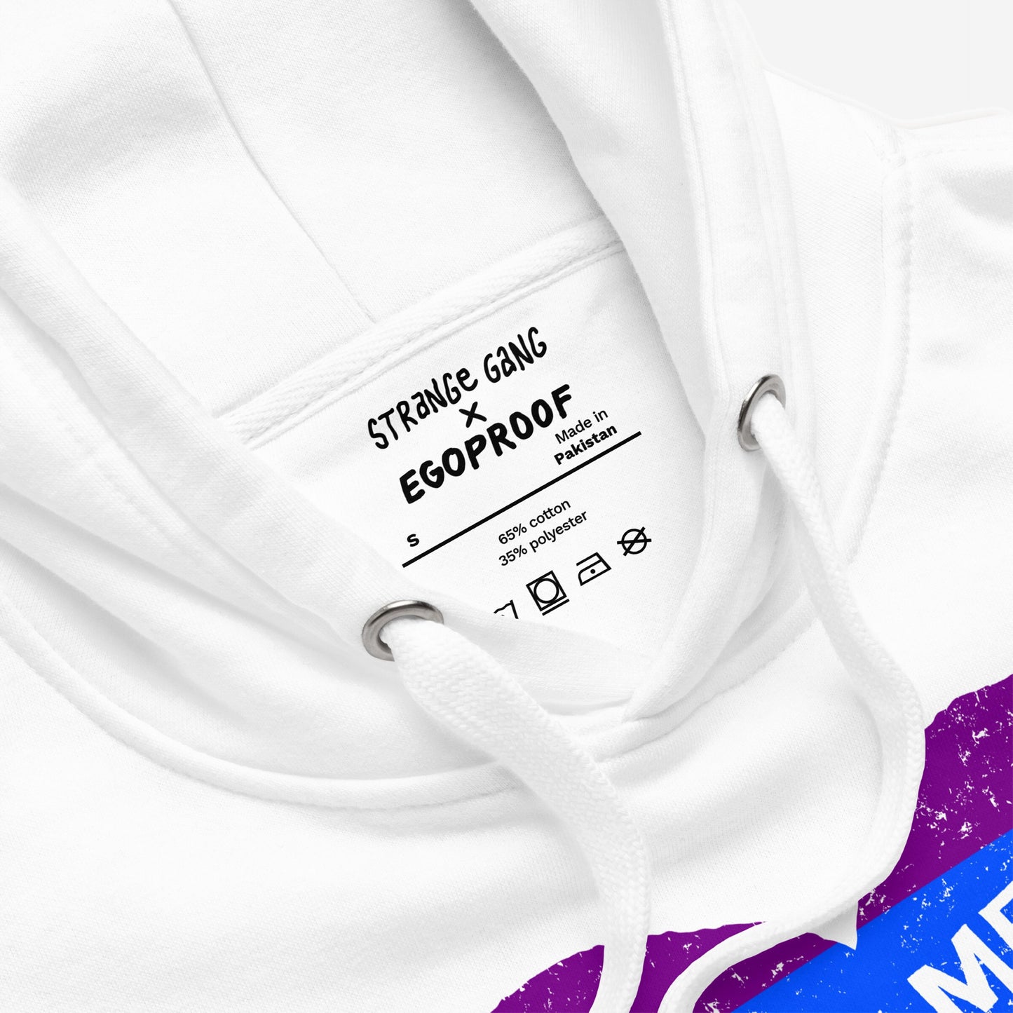 Close-up of No LGBTQ Hate Hoodie & Sweatshirt featuring a STRANGE GANG × EGOPROOF label, drawstring, and part of a colorful graphic with a rainbow heart design symbolizing LGBTQ pride and resistance.