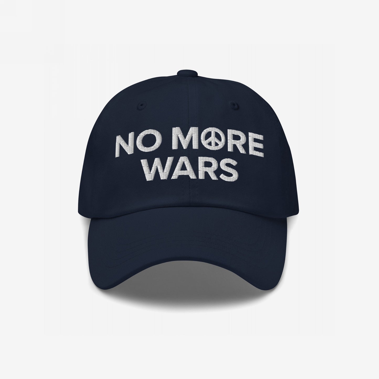 Dark-navy dad hat with NO MORE WARS in white embroidery, featuring a peace symbol, representing anti-war sentiment and activism. Part of the No More Wars Hat collection.