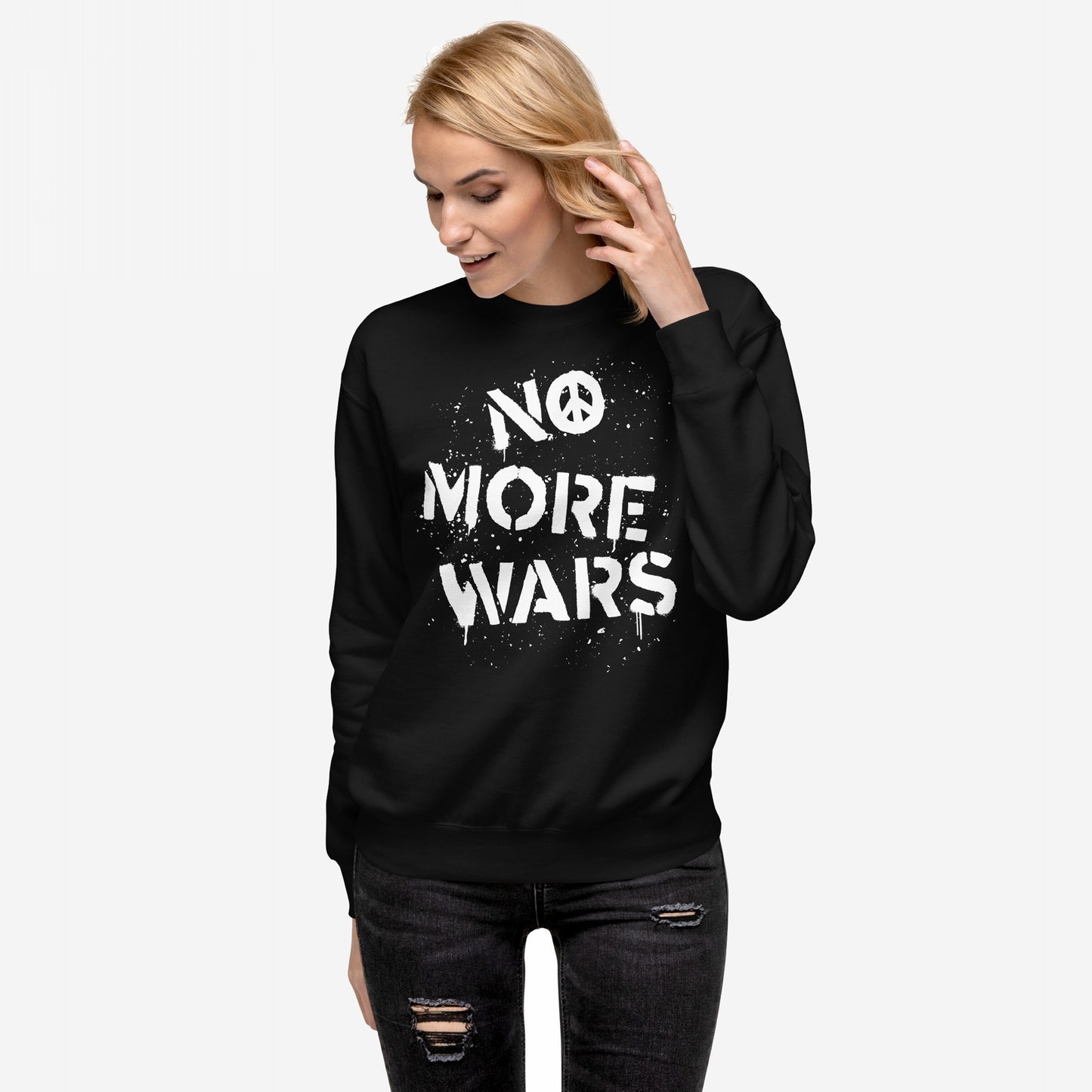 Person wearing the No More Wars Sweatshirt, featuring a bold NO MORE WARS slogan with a peace symbol, styled with distressed jeans. Represents a stand against global violence.
