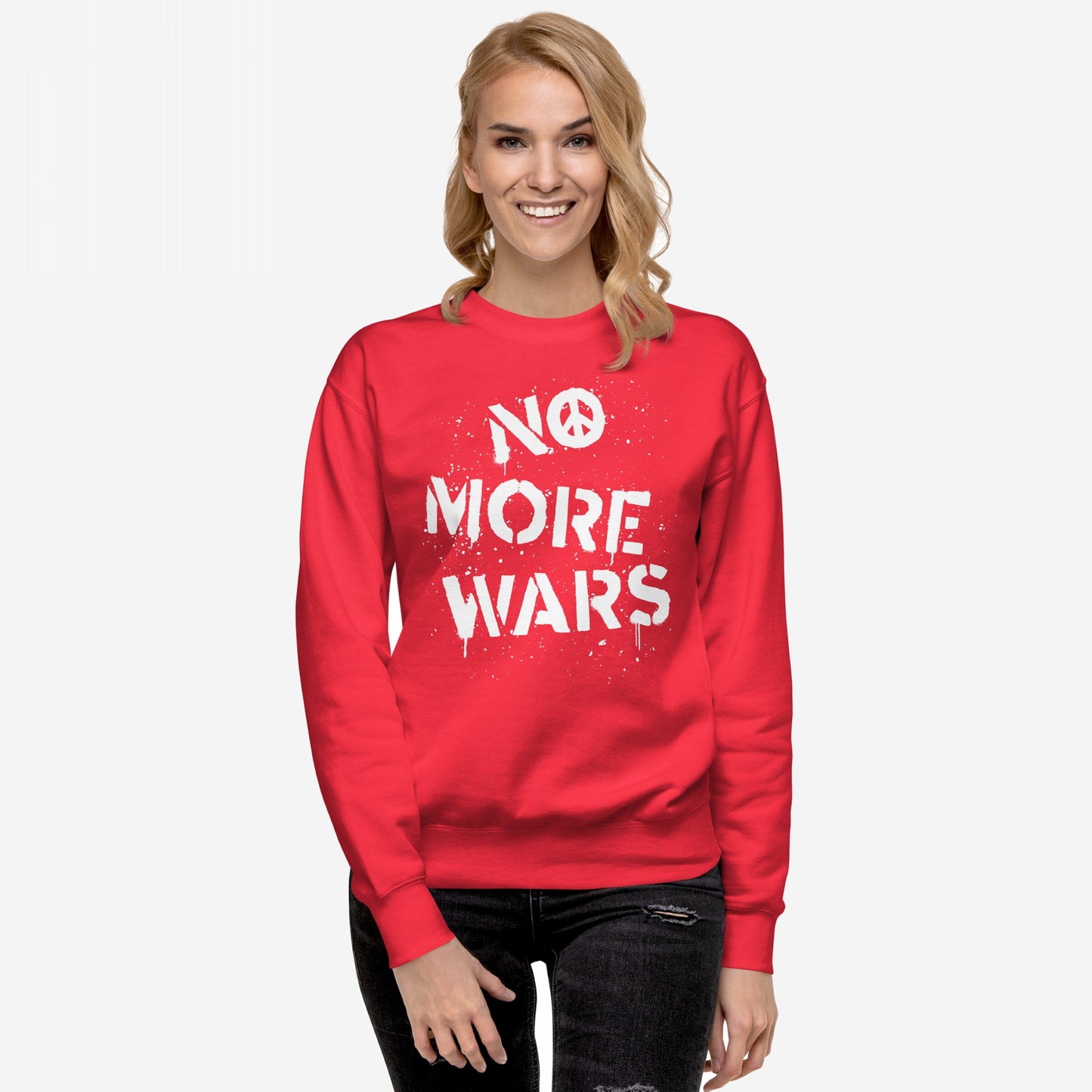 Model wearing the No More Wars Sweatshirt, featuring a white stencil-style slogan with a peace symbol, embodying a bold statement against global violence, paired with distressed jeans against a plain background.