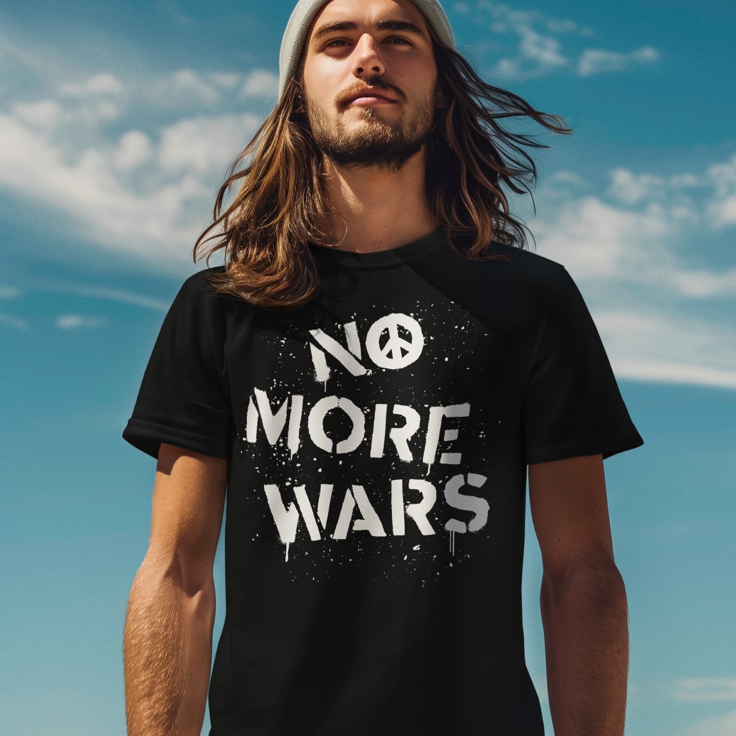 A young person wearing the No More Wars T-shirt stands outdoors. The shirt features bold, graffiti-style text with a peace symbol, reflecting a strong anti-violence message.