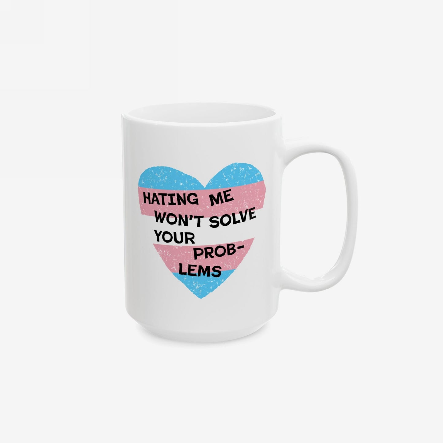 No Trans Hate Mug featuring a heart with the trans flag colors and the phrase “HATING ME WON’T SOLVE YOUR PROBLEMS,” symbolizing pride and resilience, printed on a white ceramic mug.