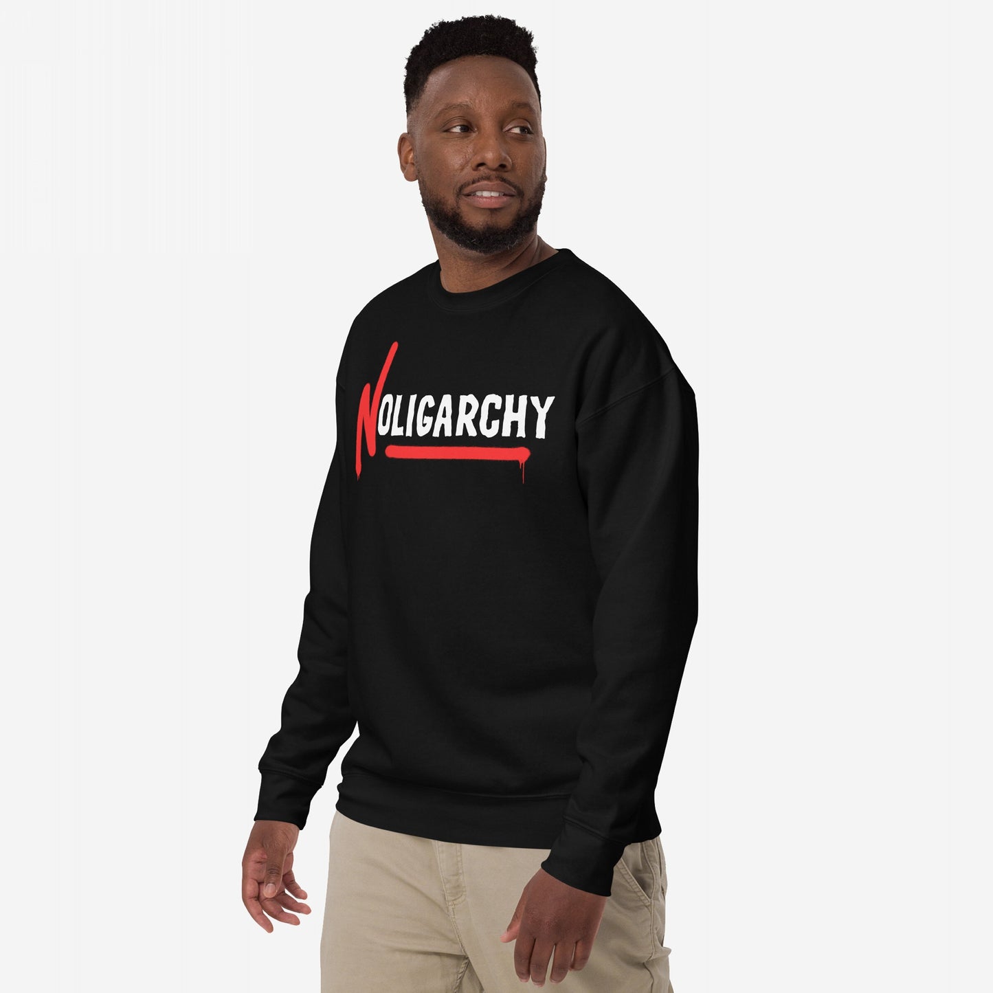 Male model wearing No Oligarchy Hoodie & Sweatshirt featuring bold white graffiti-style font with red accents. The design symbolizes resistance against elite rule, aligning with values of equality and empowerment.