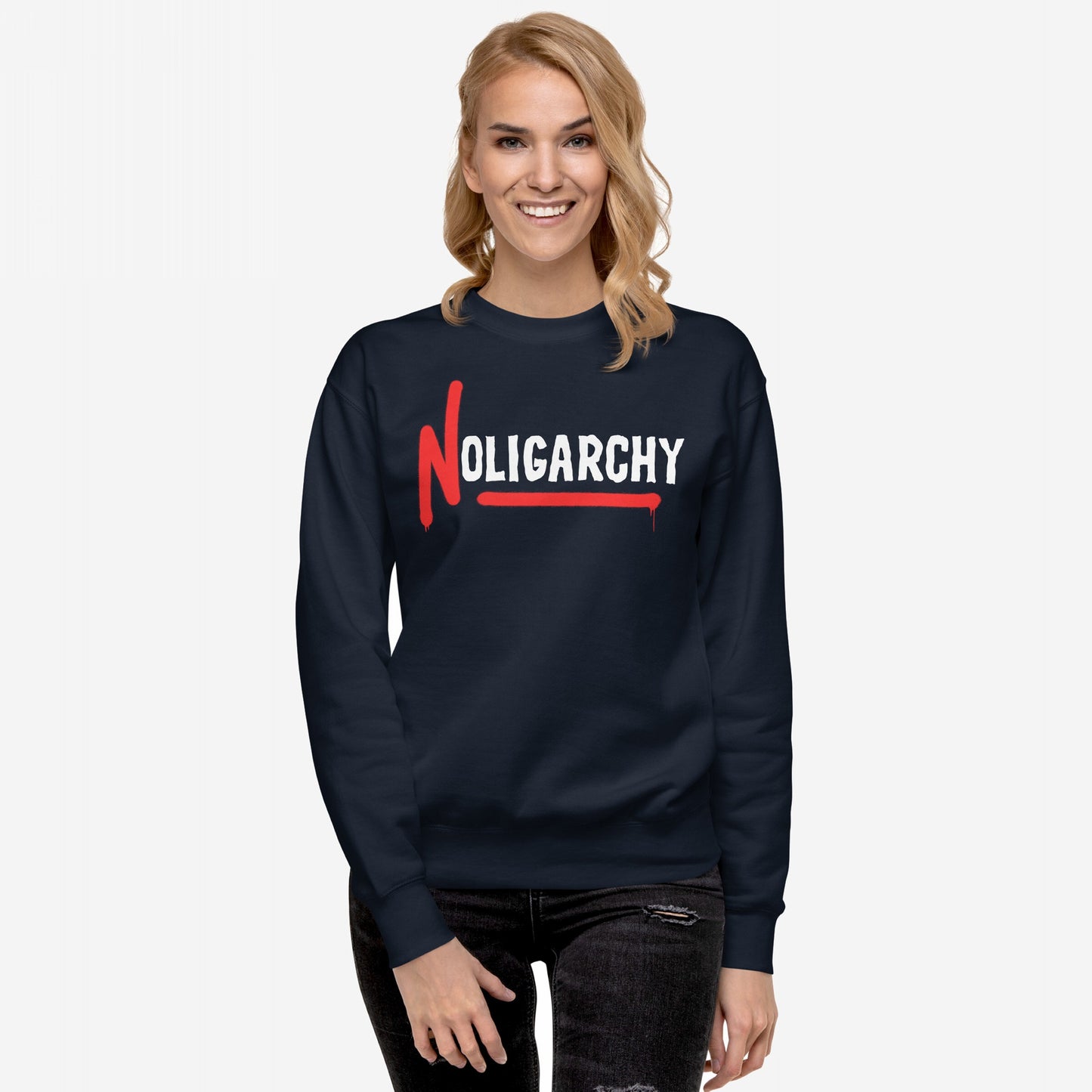 Woman wearing No Oligarchy Hoodie & Sweatshirt with bold white lettering and red paint-drip N, representing rebellion against elite rule, standing against a light background. Perfect for activists and truth-seekers.