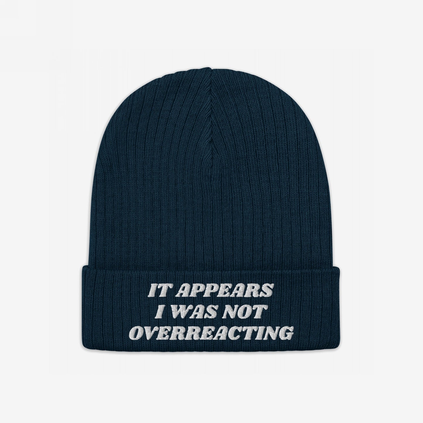 Dark-navy rib-knit beanie titled No More Wars Hat with folded cuff, featuring off-white embroidered text: It appears I was not overreacting, symbolizing an anti-war stance.