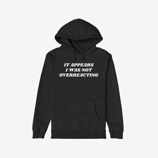 Overreacting Hoodie & Sweatshirt features bold white text asserting IT APPEARS I WAS NOT OVERREACTING, on a black pullover, embodying resistance and truth against oppression. Perfect for those challenging systemic injustices.