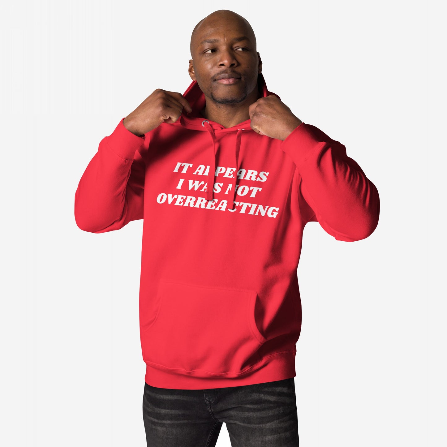Man models the Overreacting Hoodie, adjusting the hood. The bold white slogan, IT APPEARS I WAS NOT OVERREACTING, symbolizes resistance and defiance against oppressive systems, aligning with the store's activist ethos.