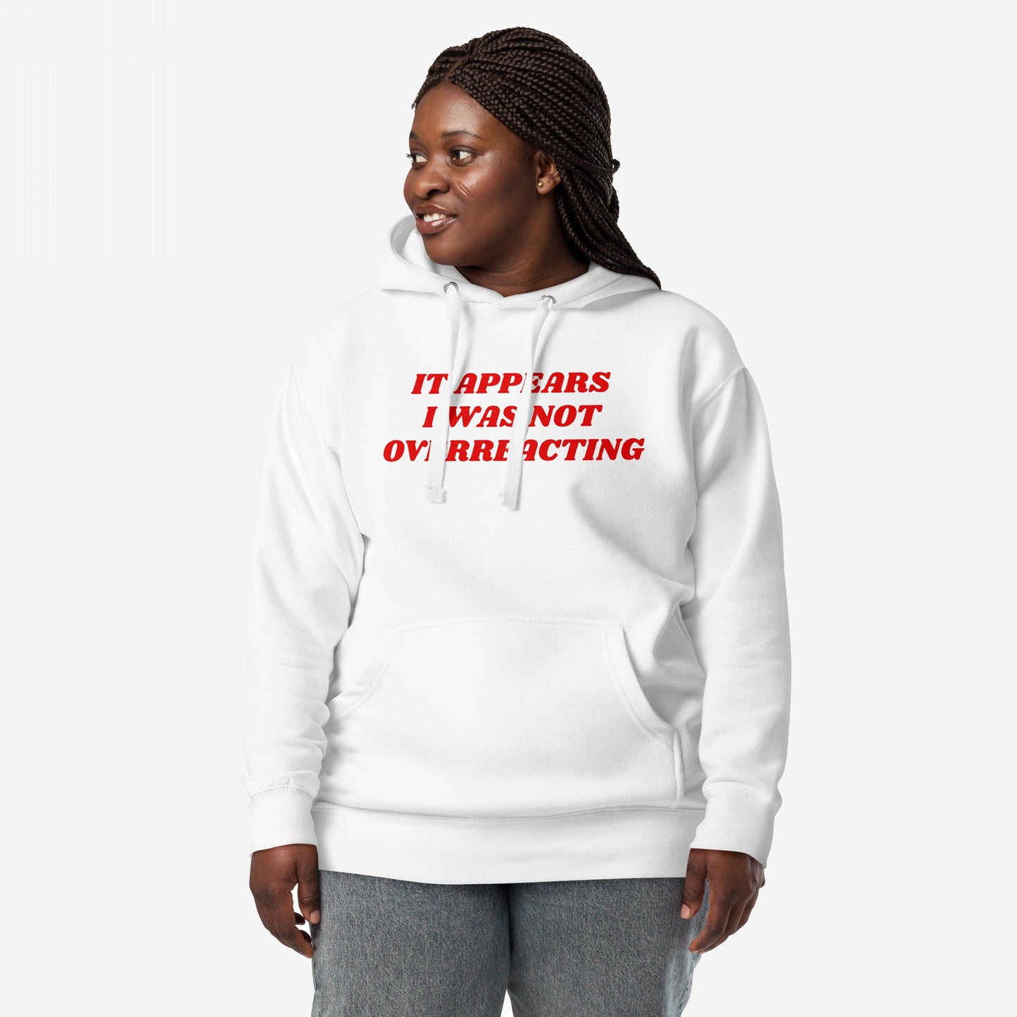 Overreacting Hoodie & Sweatshirt featuring bold red text, IT APPEARS I WAS NOT OVERREACTING, stands as a statement against oppressive systems. Designed with a kangaroo pocket and drawstrings.