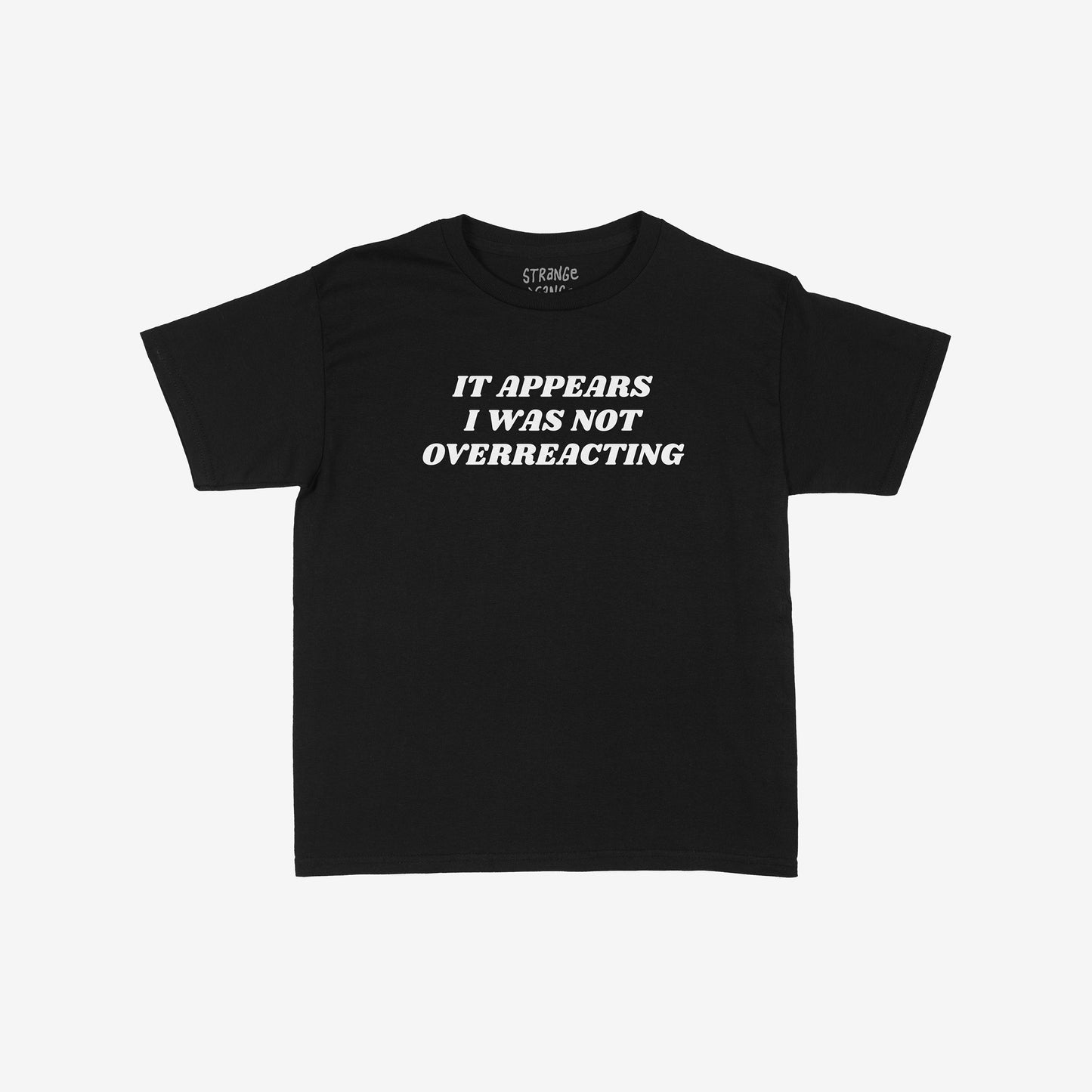 Black Overreacting T-shirt with bold white text: IT APPEARS I WAS NOT OVERREACTING on the front, embodying defiant truth and vindication. Brand name visible in the neckline.