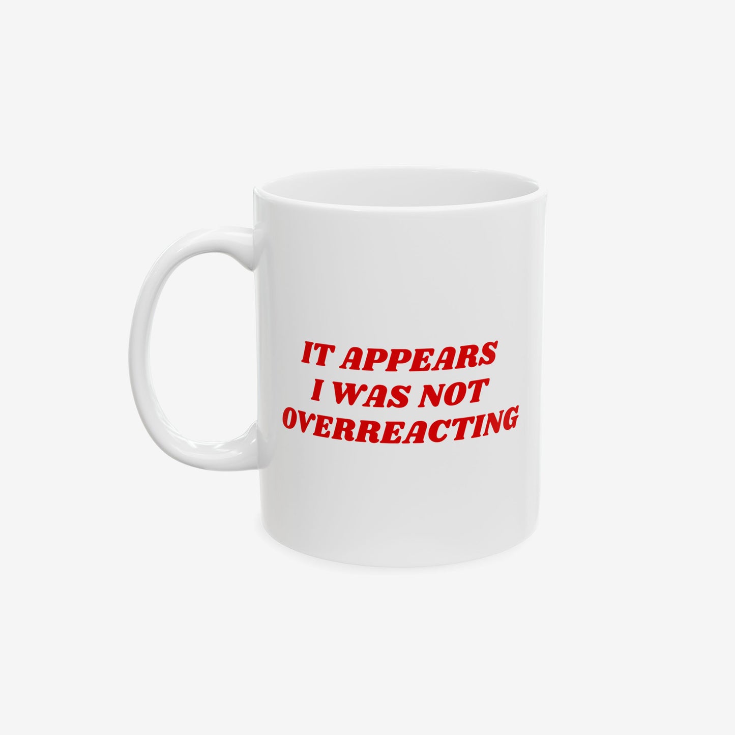 White ceramic Overreacting Mug with bold red text: “IT APPEARS I WAS NOT OVERREACTING.”, embodying progressive, anti-fascist spirit. Dishwasher-safe, available in 11 oz and 15 oz sizes.