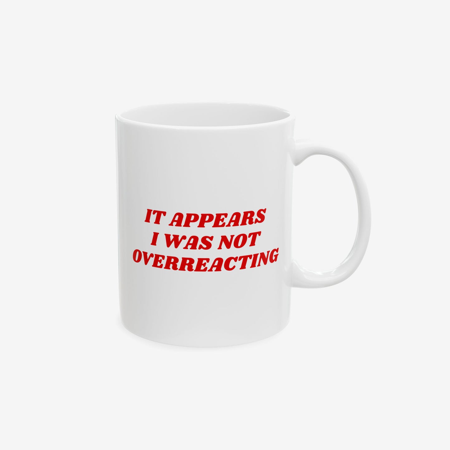 White ceramic Overreacting Mug with bold red text: “IT APPEARS I WAS NOT OVERREACTING.” Right-hand handle. Ideal for anti-fascists and progressives. Dishwasher-safe, available in 11 oz. and 15 oz.