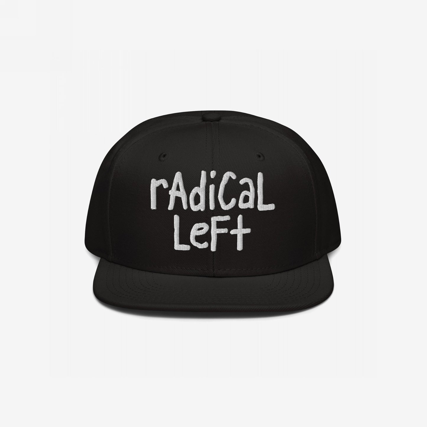 Black snapback cap with white radical left embroidery in a hand-drawn style, embodying a progressive spirit. Quietly comfortable yet bold, reflecting values of equality and resistance against fearmongering.