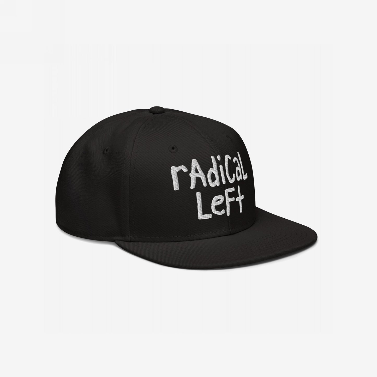 The Radical Left Hat features white rAdical Left embroidery on a black, flat-brimmed baseball cap, capturing a bold, progressive message with its laid-back, hand-drawn design.